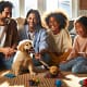 A happy family interacting with a mini golden retriever puppy